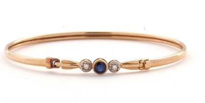 Lot 145A - A sapphire and diamond bangle, set with a...