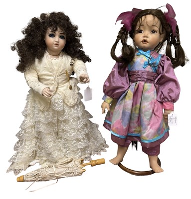 Lot 221 - A pair of porcelain collector's dolls, to...