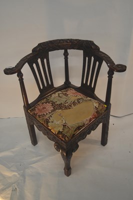 Lot 436 - A Victorian carved oak corner chair decorated...