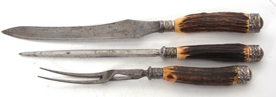 Lot 201 - An antique three piece carving set, each with...