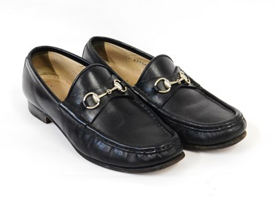 Lot 76 - Gucci: a pair of black leather loafers with...