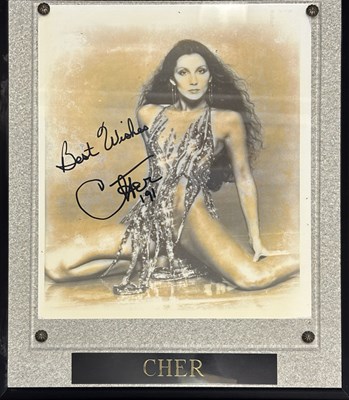 Lot 124 - CHER: Signed photograph under perspex and...