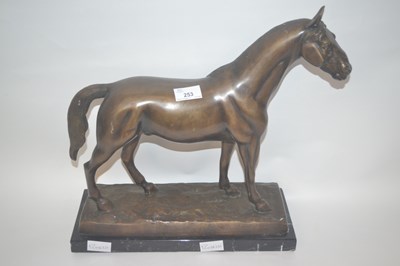 Lot 260 - A bronzed metal model of a stallion on...