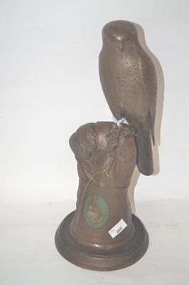 Lot 260 - A ceramic model of a eagle, held in a gloved...