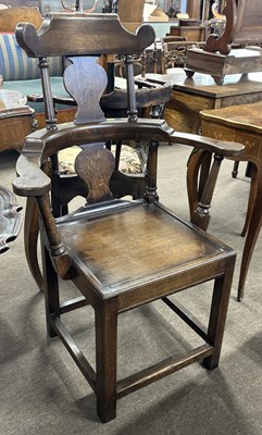 Lot 406 - An unusual George III oak high back armchair...