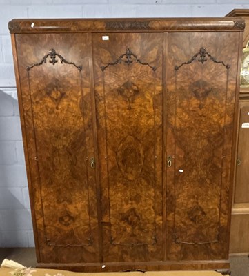 Lot 431 - An early 20th Century figured walnut triple...