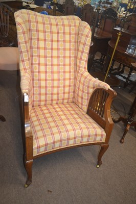 Lot 470 - An Edwardian wing back armchair with mahogany...