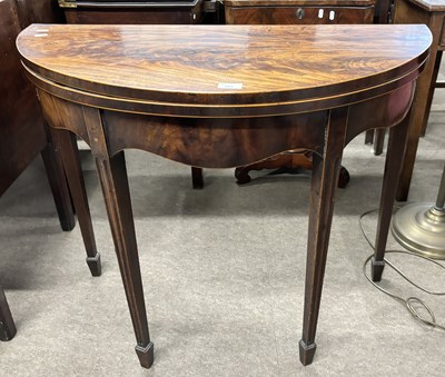 Lot 409 - A Georgian mahogany demi lune tea table with...