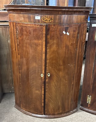 Lot 583 - A George III mahogany bow front wall mounted...