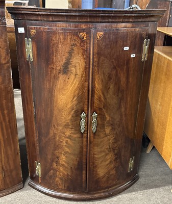 Lot 514 - A George III mahogany bow front two door wall...