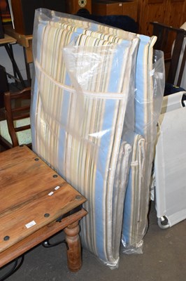 Lot 724 - A pair of garden loungers and cushions