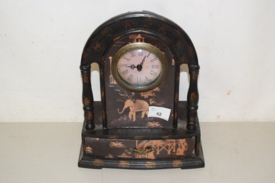 Lot 42 - A mantel clock with Indian scene and drawer below
