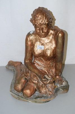 Lot 184 - A ceramic model of a girl on rocky composite base