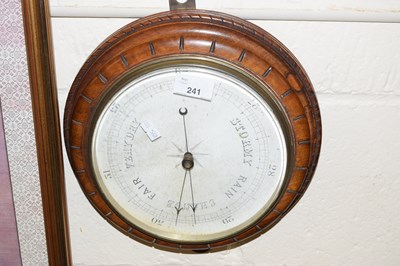 Lot 241 - A barometer in circular carved wooden frame