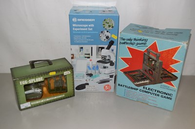 Lot 501 - A microscope battleship game and egg cup set