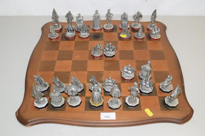 Lot 600 - A wooden chess board together with pewter...