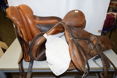 Lot 654 - Three leather riding saddles