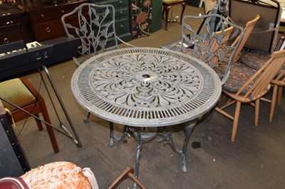 Lot 711 - An iron outdoor patio table and two chairs