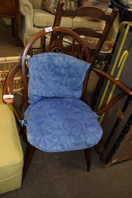 Lot 806 - A cushioned wooden armchair