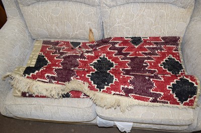 Lot 760 - A retro burgundy and red floor rug