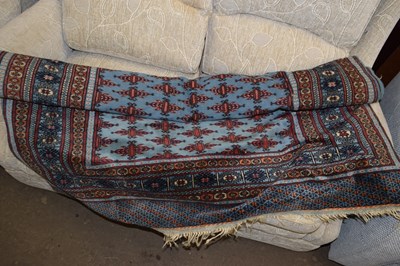 Lot 761 - A blue and red geometric floor rug