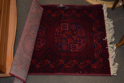 Lot 766 - A red and blue geometric floor rug