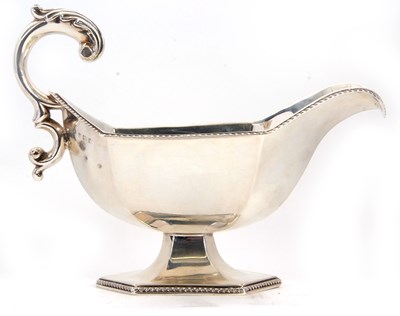 Lot 14 - A large Edwardian silver pedestal sauce boat...
