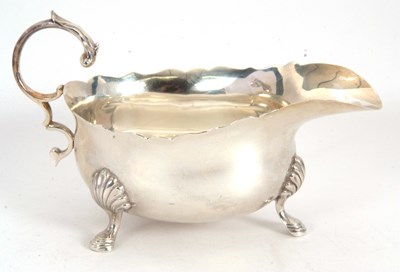 Lot 43 - A George V silver sauce boat of typical form,...