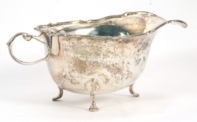 Lot 46 - A George V silver sauce boat of typical form,...