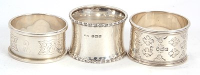 Lot 48 - Group of three silver serviette rings, two...