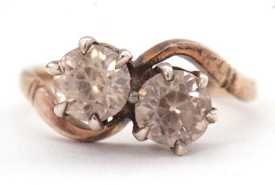 Lot 40 - A zircon 'toi et moi' ring, the two round...
