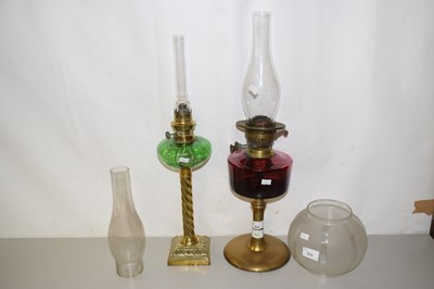 Lot 523 - Two oil lamps plus extra shades