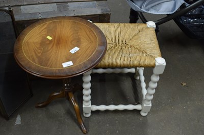 Lot 820 - A small round wooden table and a footstool