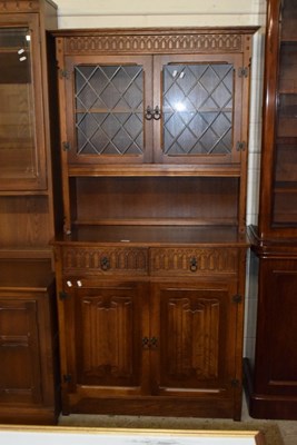 Lot 265 - A modern oak lead glazed side cabinet with...