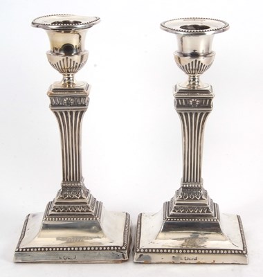 Lot 96 - A pair of Edwardian silver candlesticks of Neo...