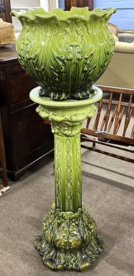 Lot 462 - A Victorian green glazed jardiniere and stand,...