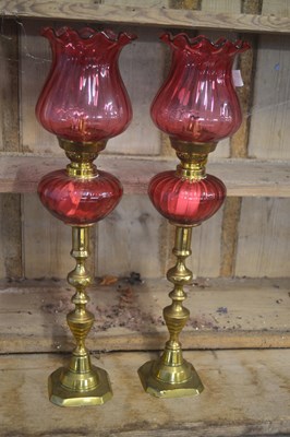 Lot 478 - A pair of small cranberry oil lamps, the bases...
