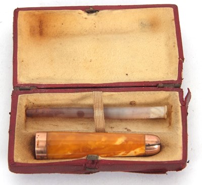 Lot 123 - A cased early 20th Century amber and 9ct gold...