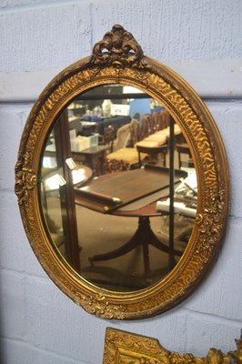 Lot 474 - A 20th Century oval wall mirror in a gilt...