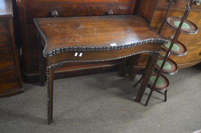 Lot 512 - A Georgian mahogany card table of serpentine...