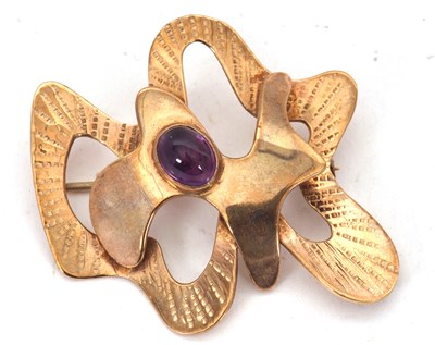 Lot 115 - A modernist amethyst brooch, the abstract...