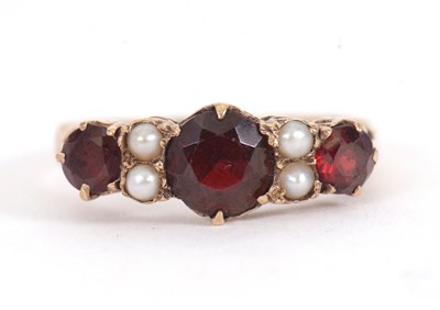 Lot 1 - A garnet and cultured pearl ring, the three...