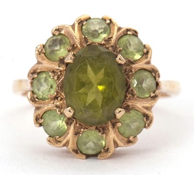 Lot 52 - A 9ct peridot and green stone cluster ring,...