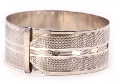 Lot 175 - A silver buckle bangle, 25mm deep, adjustable,...