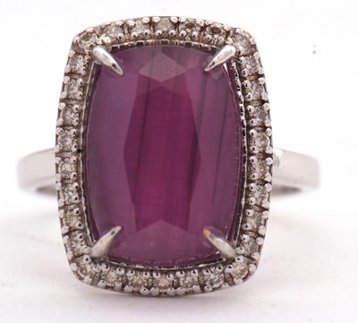 Lot 90 - A ruby and diamond ring, the central cushion...