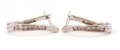 Lot 114 - A pair of 9ct diamond earrings, the slightly...