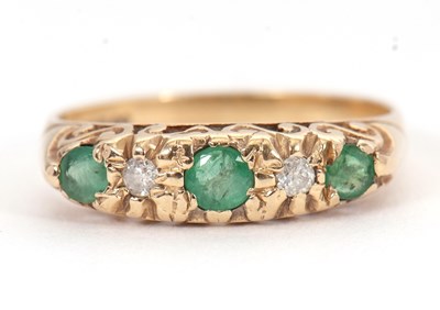 Lot 12 - A 9ct emerald and diamond ring, with three...