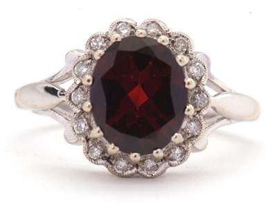 Lot 8 - A 9ct garnet and diamond ring, the oval garnet...