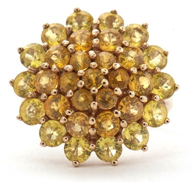 Lot 92 - A 9ct yellow sapphire cluster ring, set with...