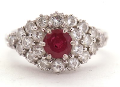 Lot 69 - An 18ct ruby and diamond ring, the central...